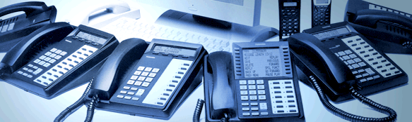 Many Phones around a Computer Displayed by Sierra Telephone Systems, Inc.